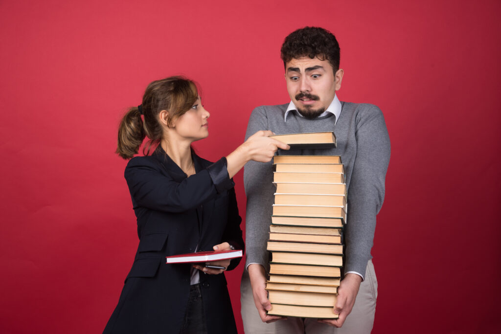 Woman employee taking single book from her colleague